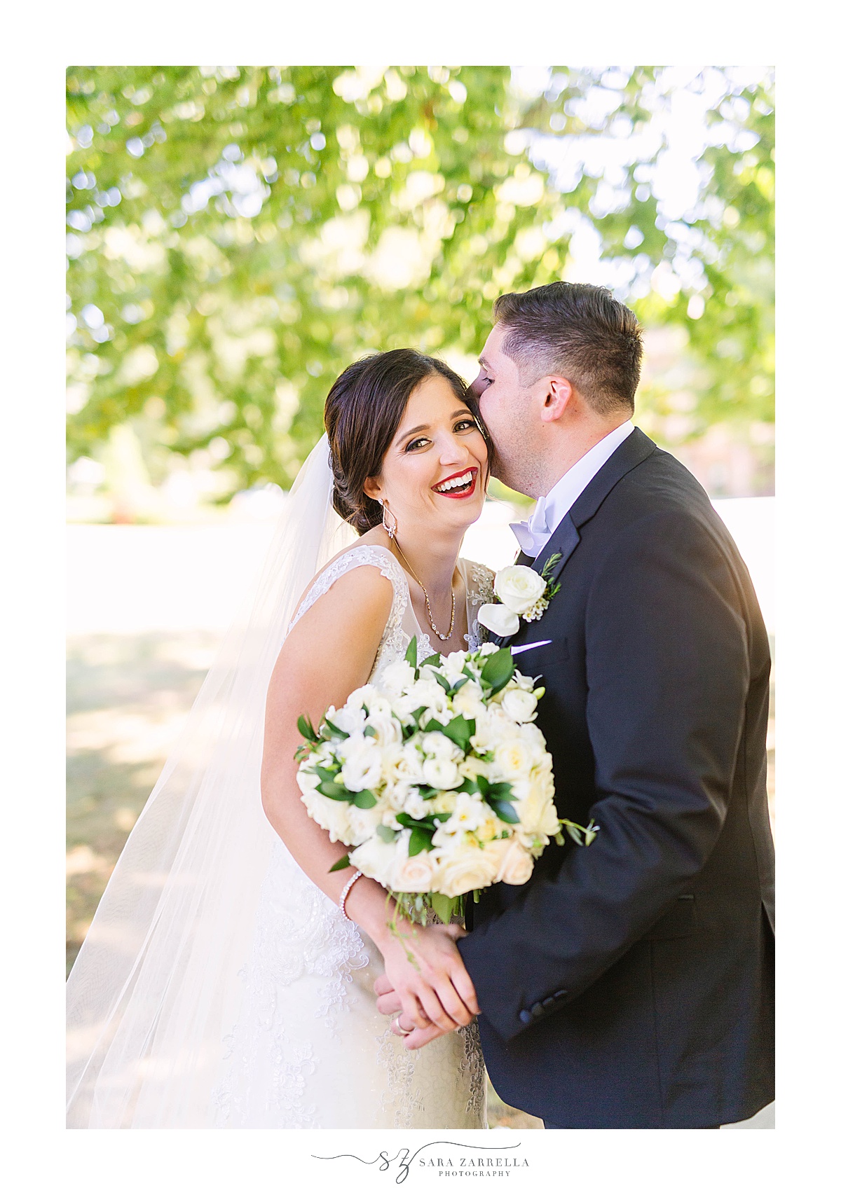 groom kisses bride's cheek during Rhode Island wedding photos