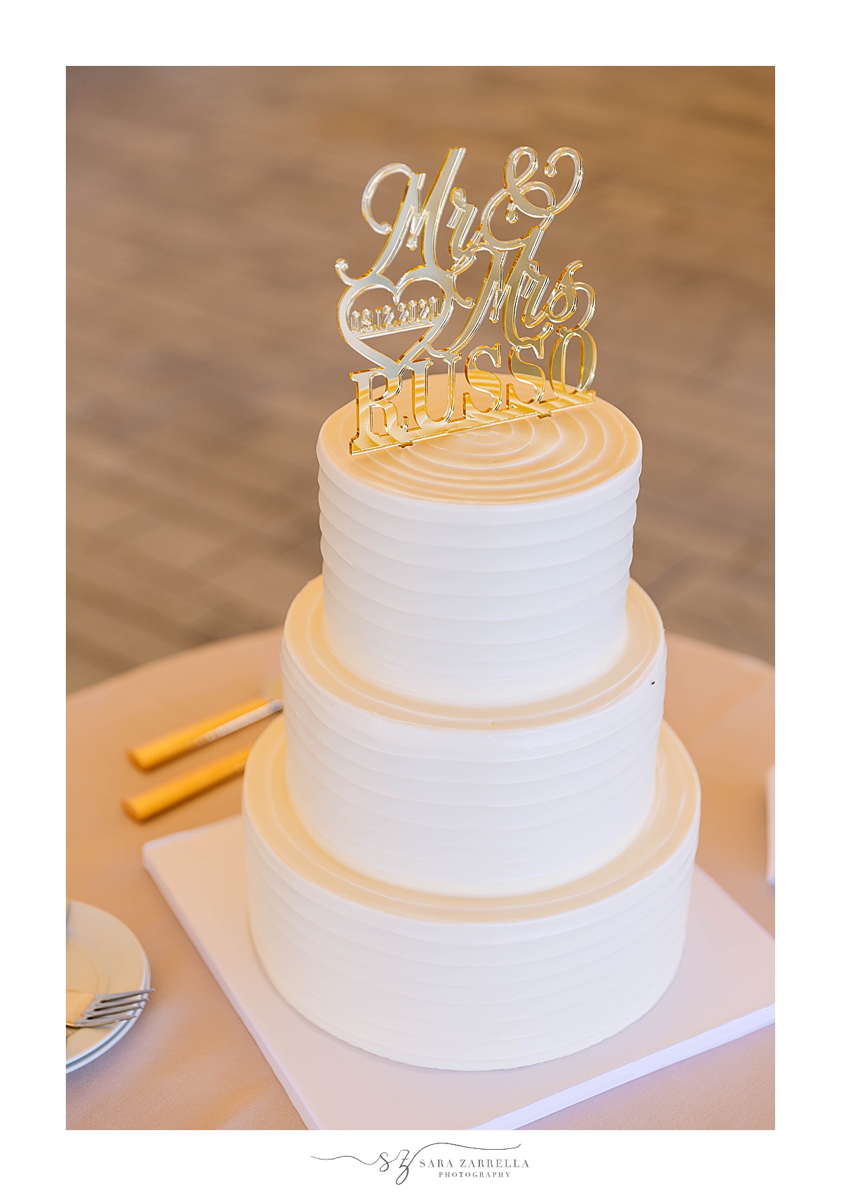 tiered wedding cake with gold topper