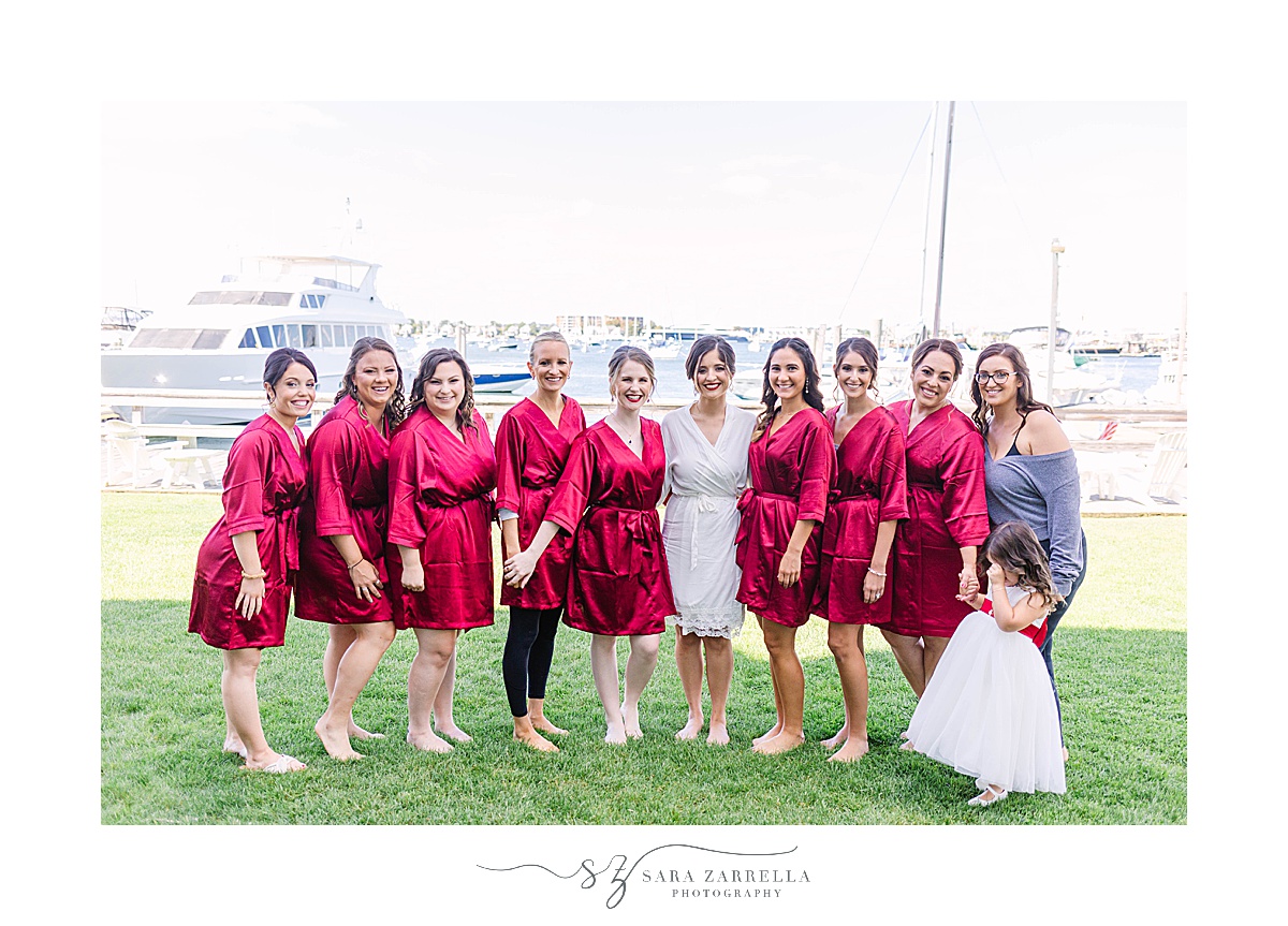 bridesmaids pose with bride in red robes