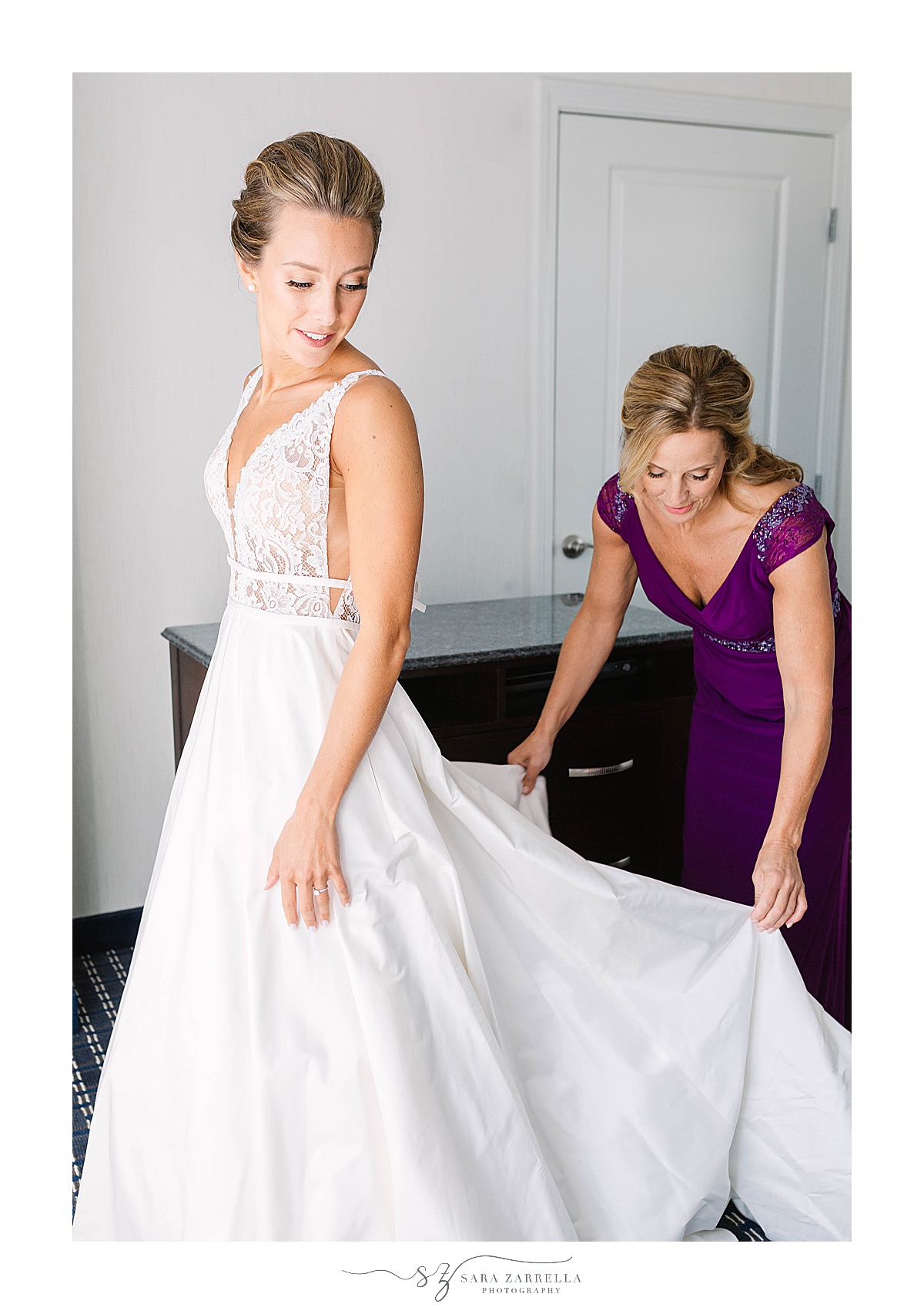 mom adjusts wedding gown for bride in RI