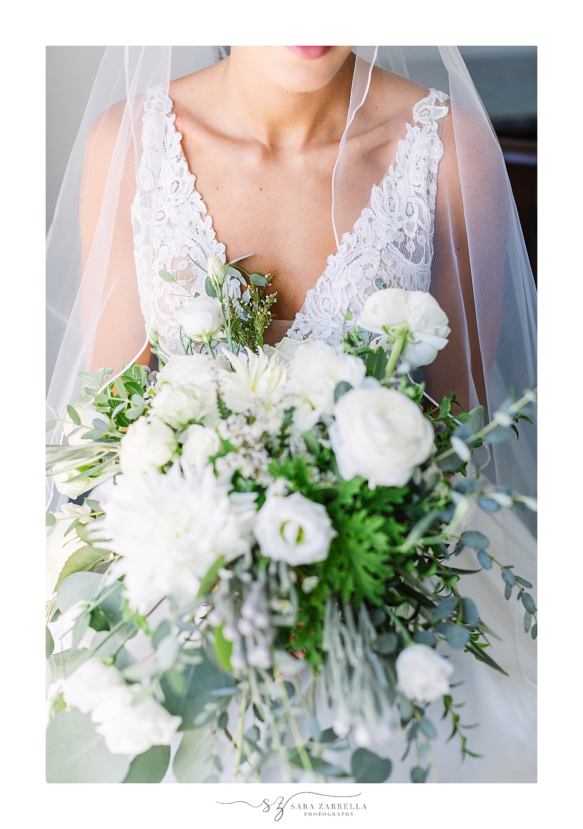 bride holds all white bouquet during portraits at Blithewold Mansion