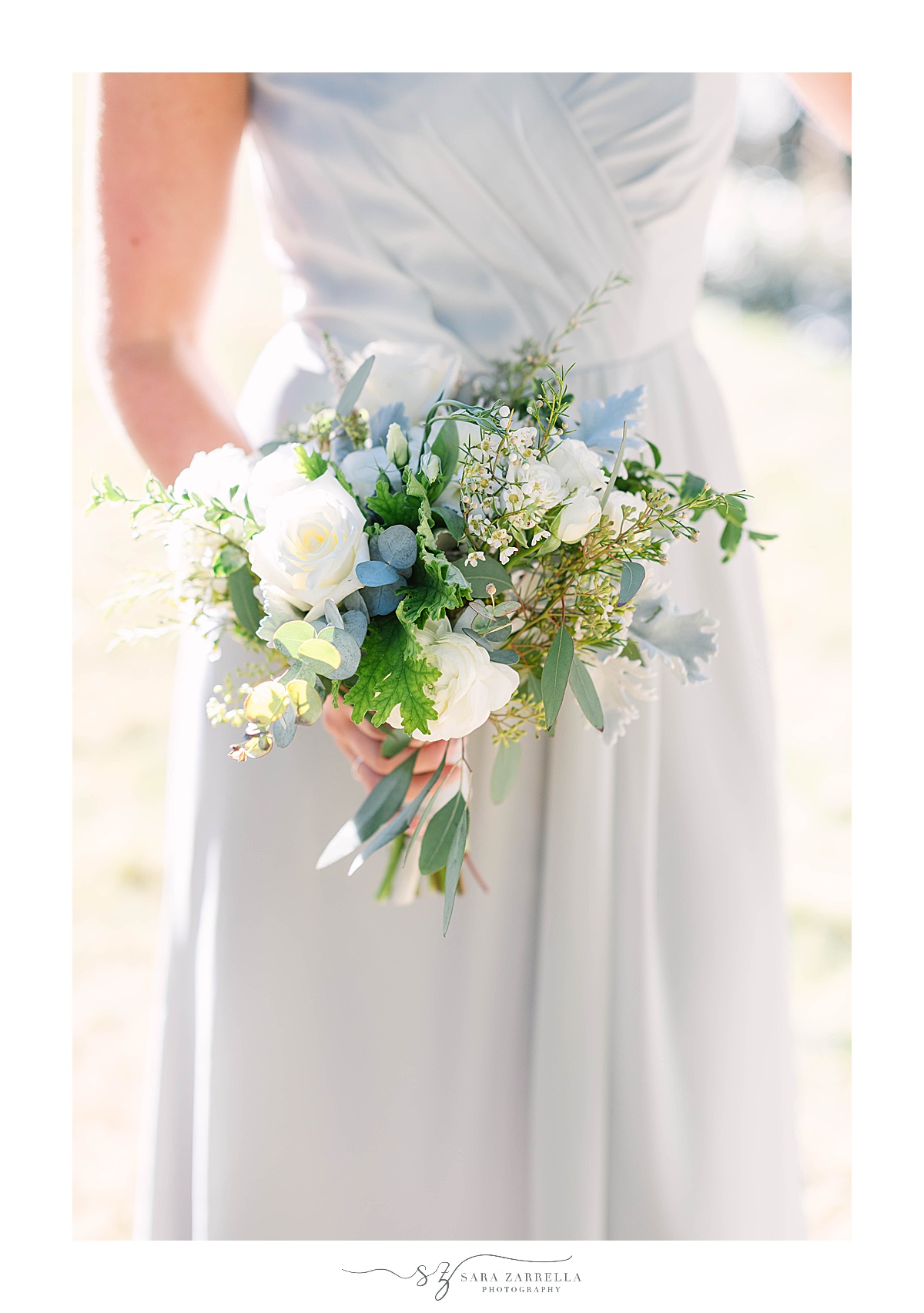 bridesmaid holds bouquet of white flowers