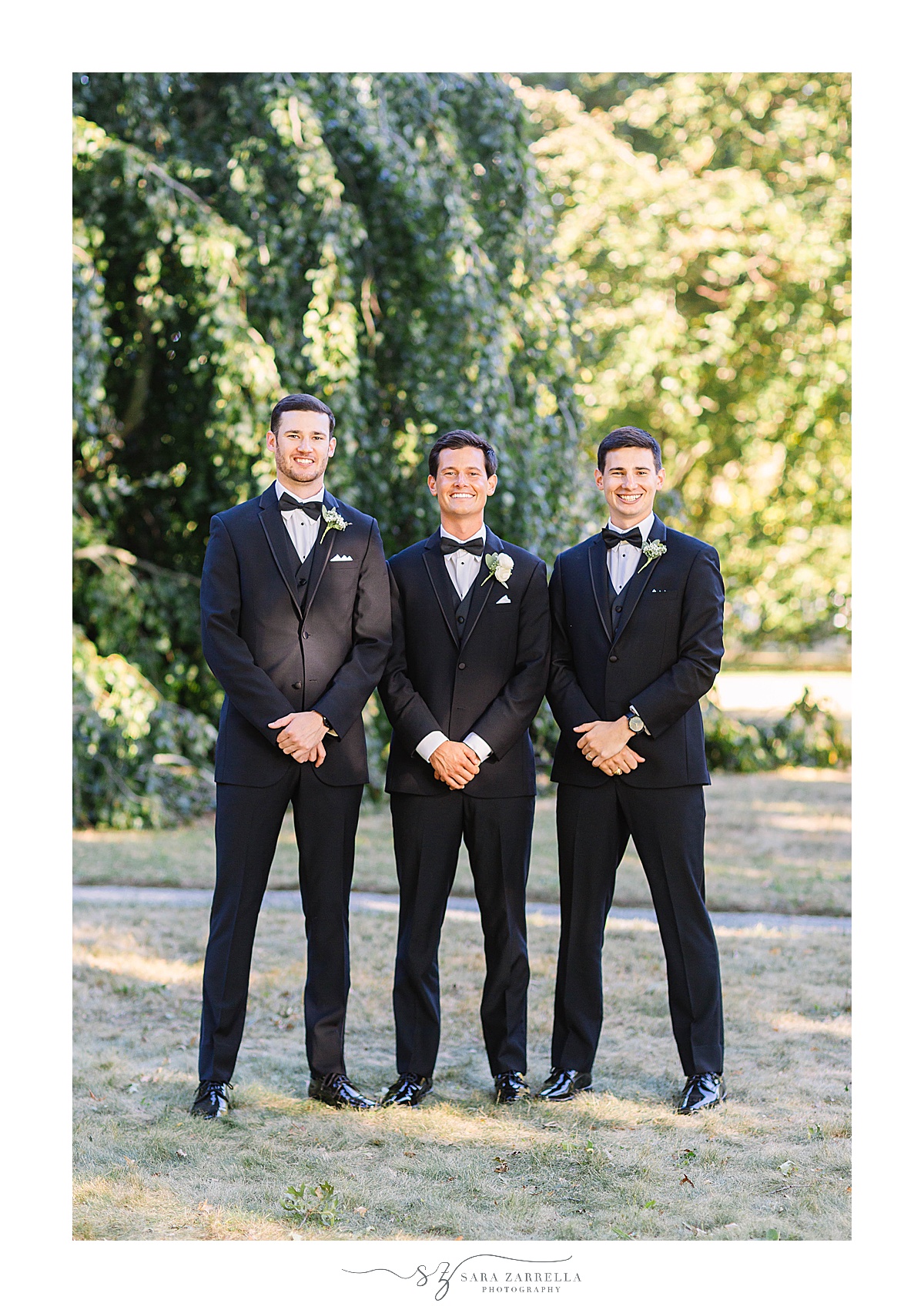 groom poses with brothers on wedding day