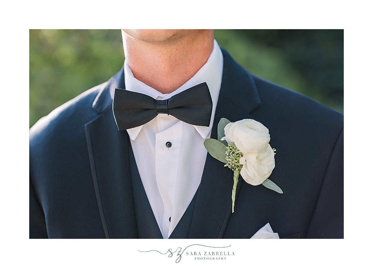 groom in classic tux with simple white boutineere