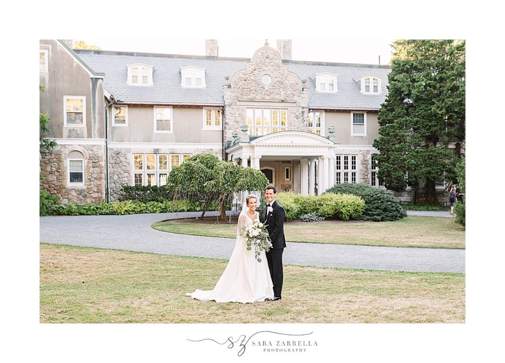 newlyweds pose in front of Blithewold Mansion