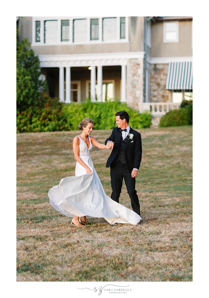 groom twirls bride during portraits at Blithewold Mansion