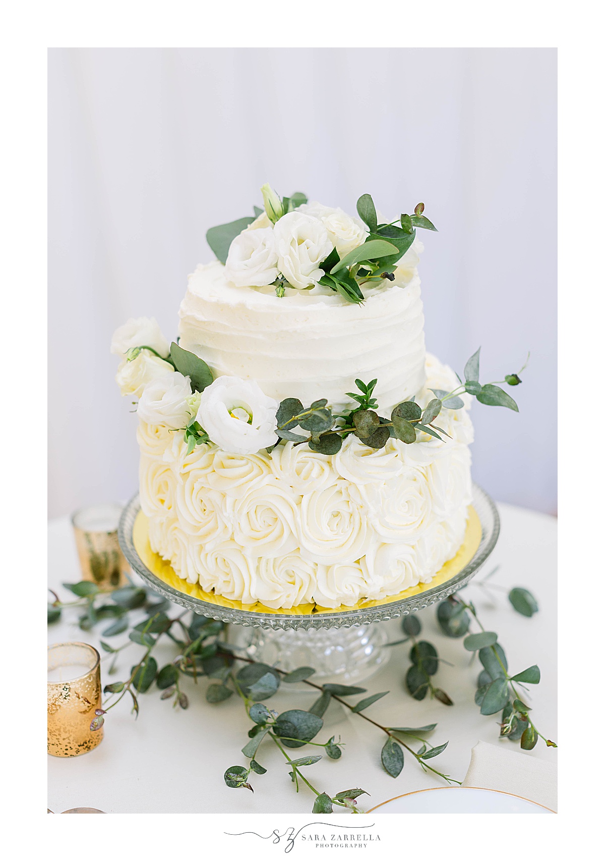 tiered wedding cake with greenery accents