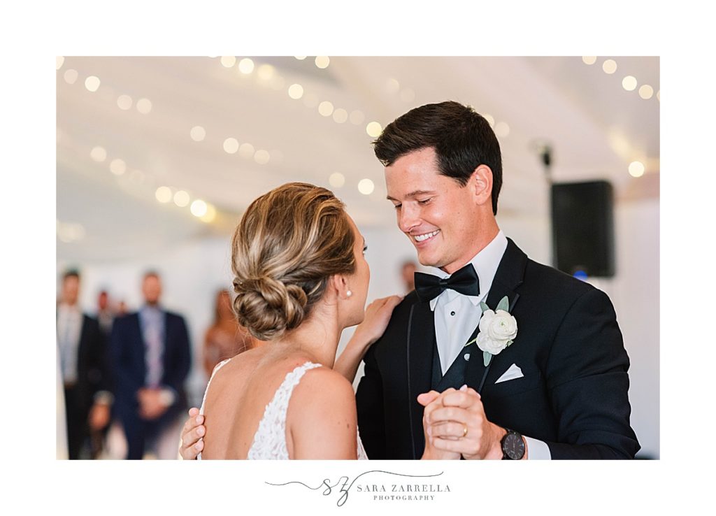 bride and groom smile during first dance