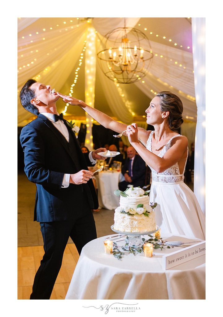 bride shoves cake in groom's face at Blithewold Mansion wedding reception