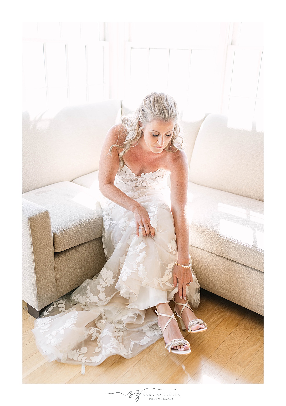 bride puts shoes on during prep before Castle Hill Inn Wedding