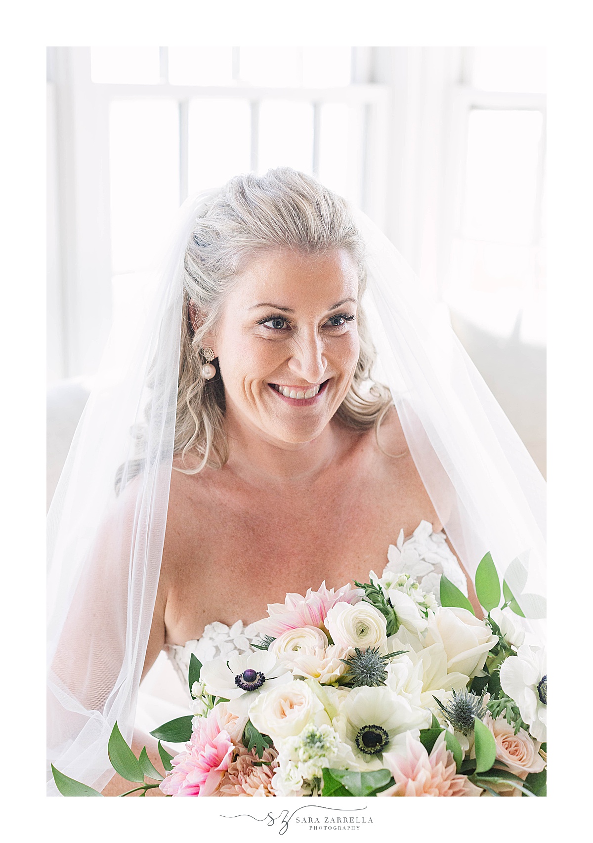 bride holds bouquet and smiles 