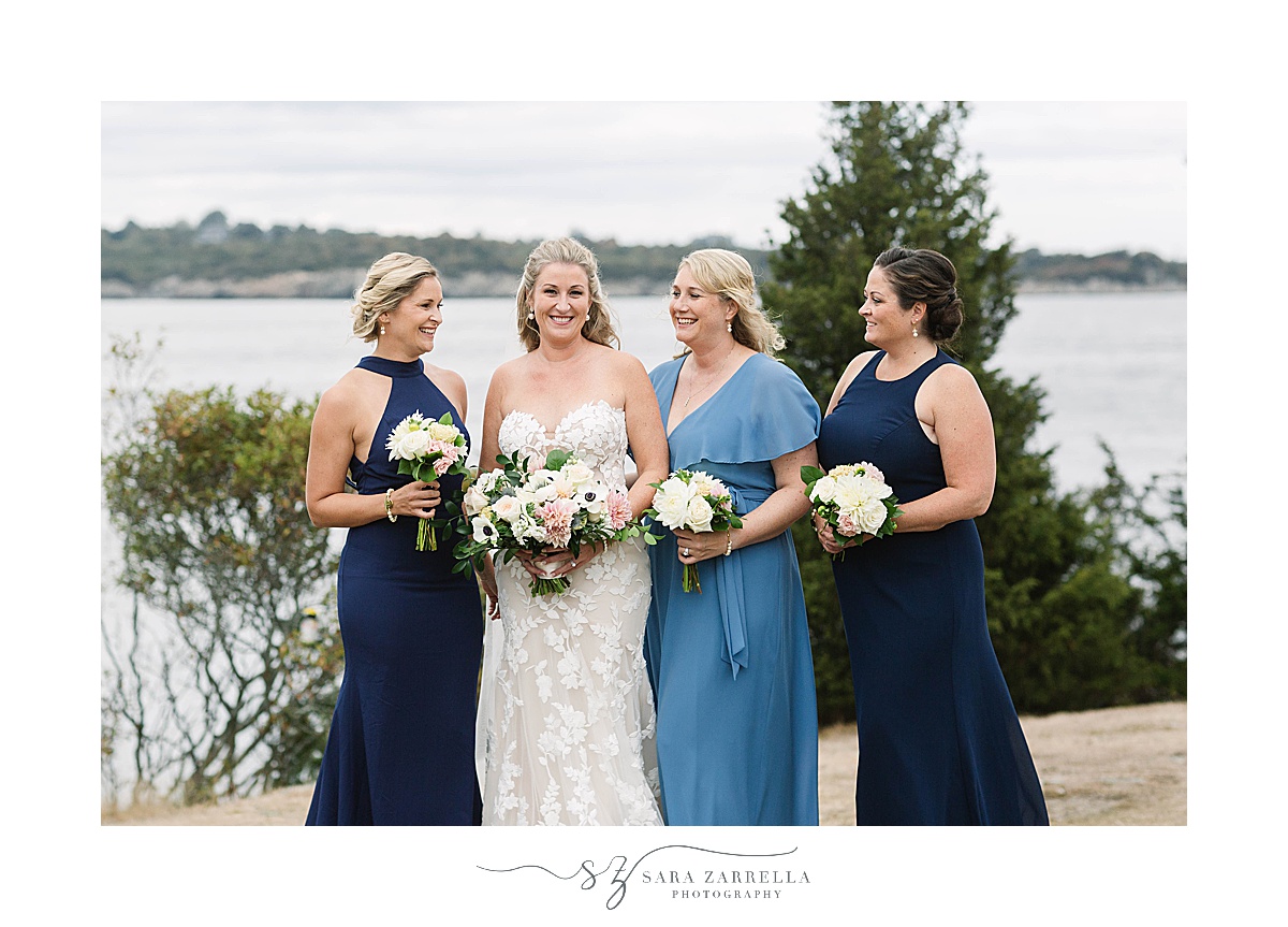 bride poses with bridesmaids in blue dresses 