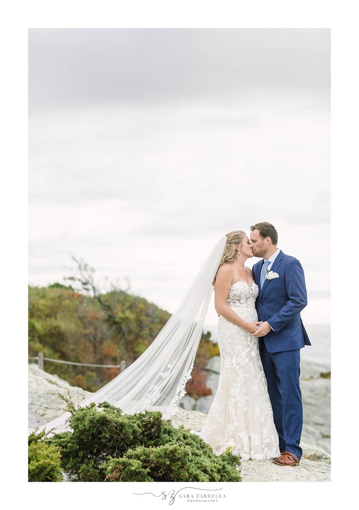 newlyweds kiss on rocks in Rhode Island