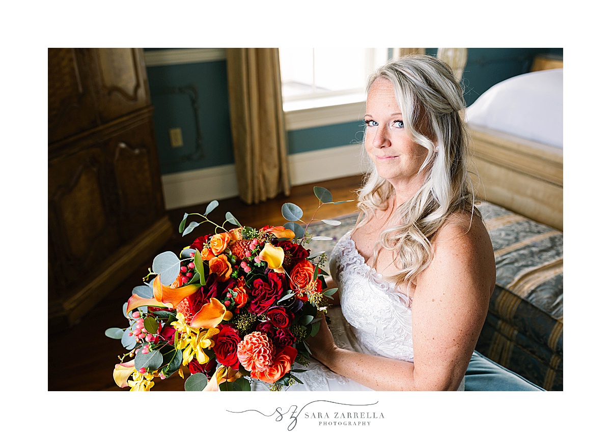bride holds fall bouquet from Sayles Livingston Design