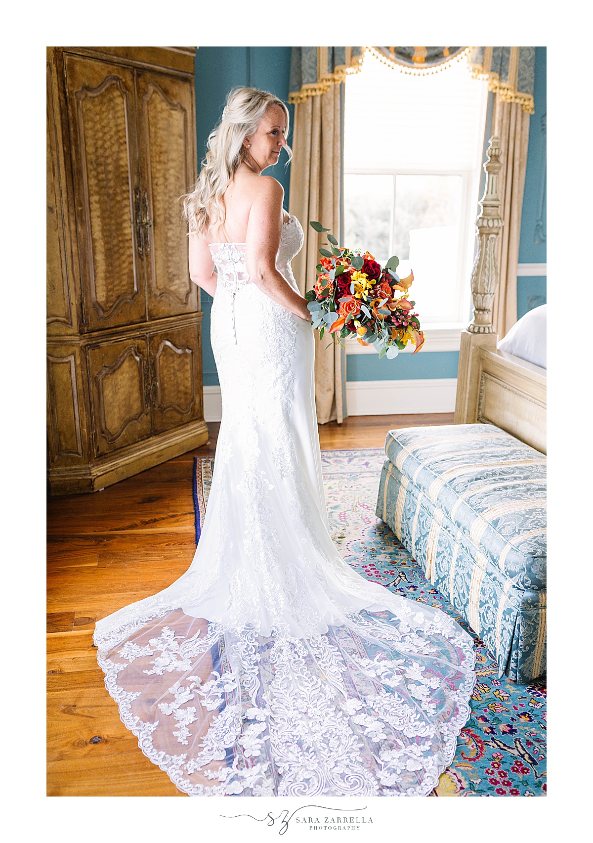 bride shows off back of wedding gown before Chanler at Cliff Walk wedding