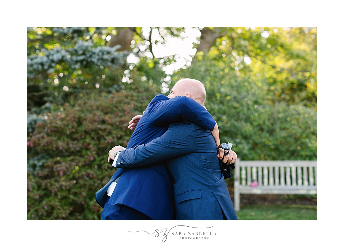 groom hugs step son during wedding photos