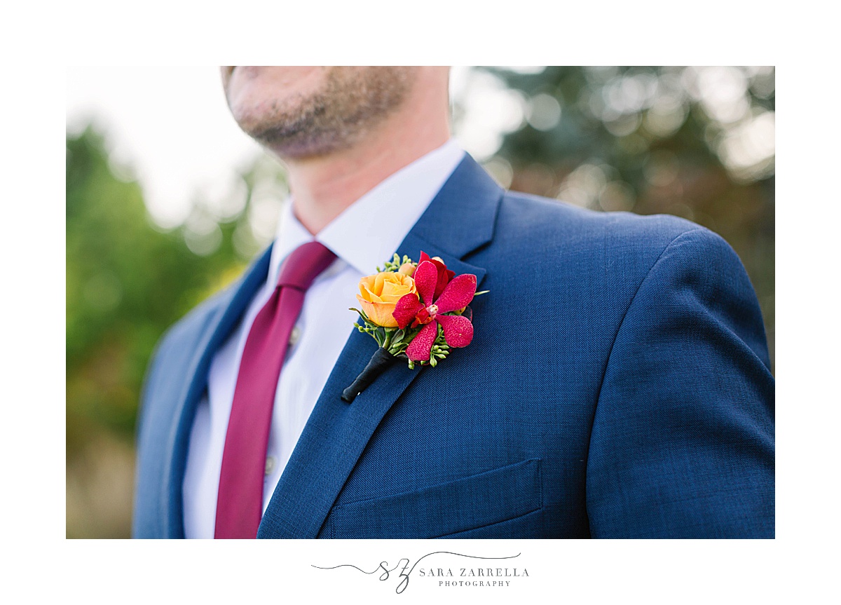 groom in navy suit with fall boutonnière 
