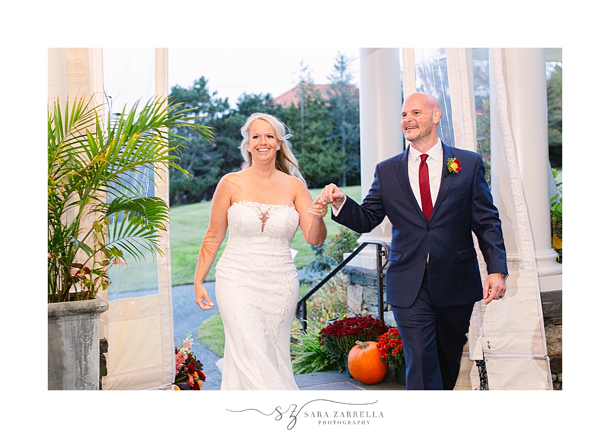 newlyweds enter reception at the Chanler at Cliff Walk