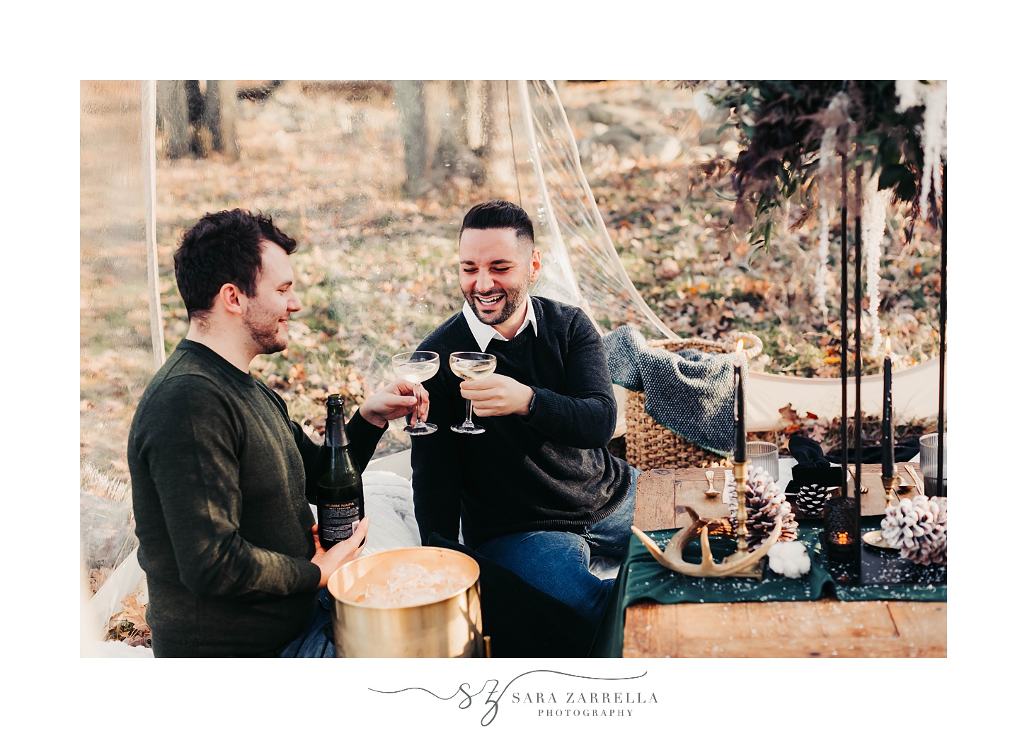 grooms toast with champagne during cozy winter proposal at Gerald's Farm