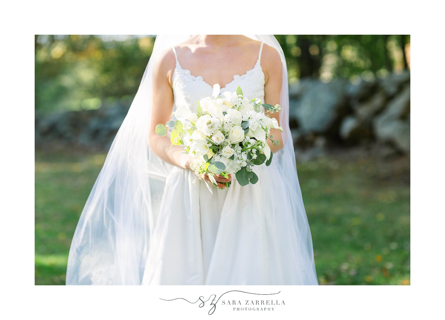 bride holds bouquet of white flowers 
