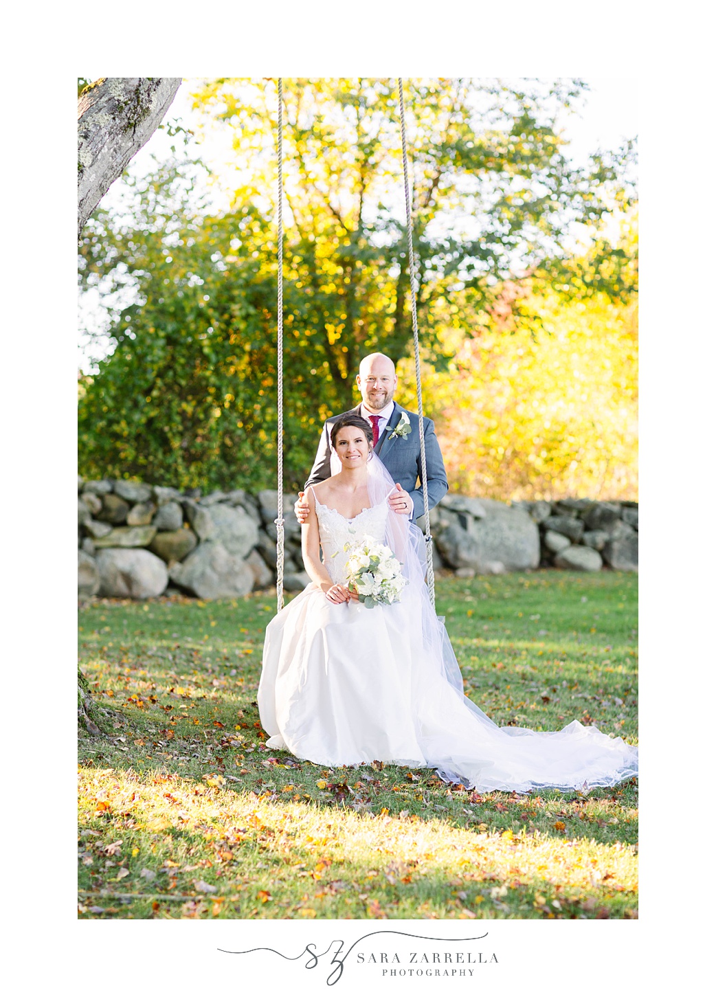 newlyweds pose on wooden swing at Gerald's Farm