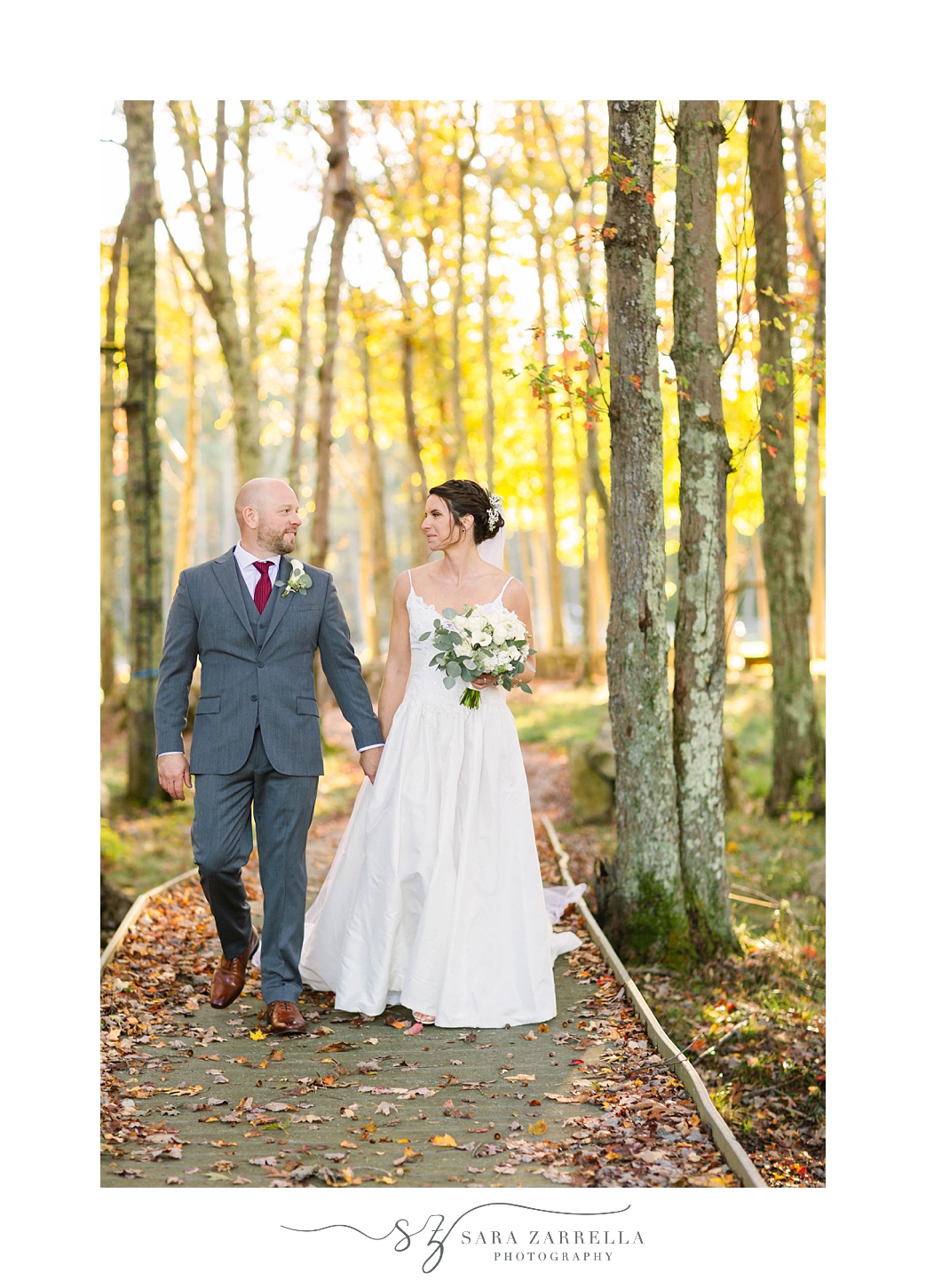 newlyweds walk together on path at Gerald's Farm
