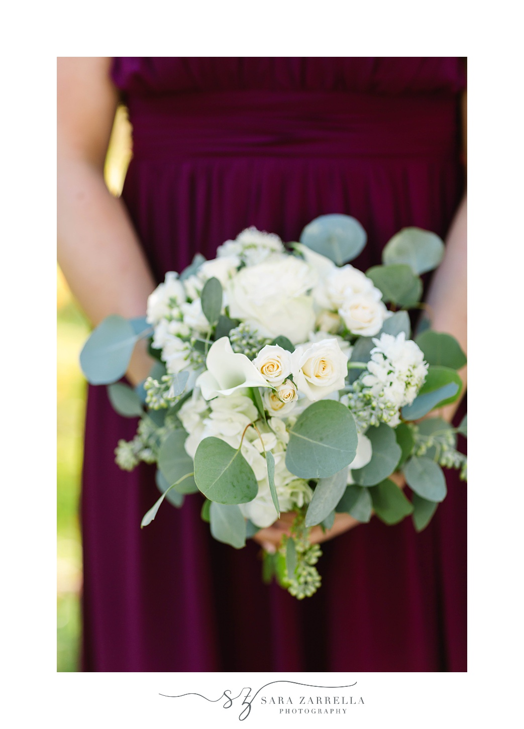 bridesmaid holds small bouquet of white flowers