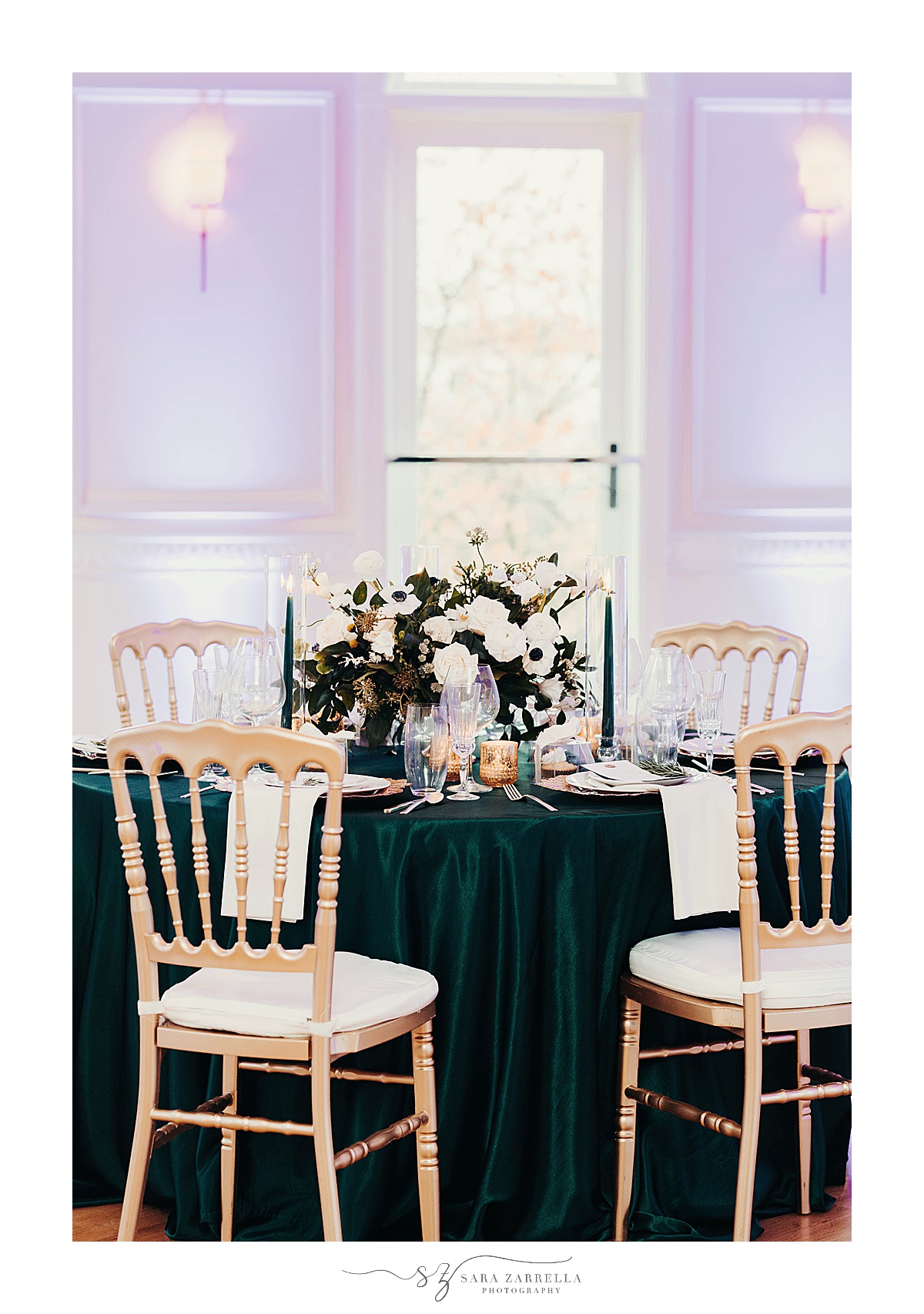 Modern Winter Wedding centerpieces sit on emerald table cloth