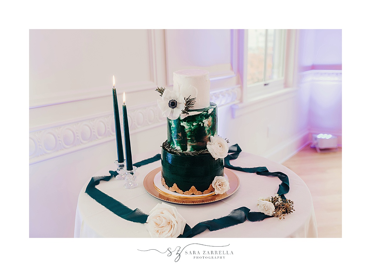 tiered wedding cake with emerald and gold details