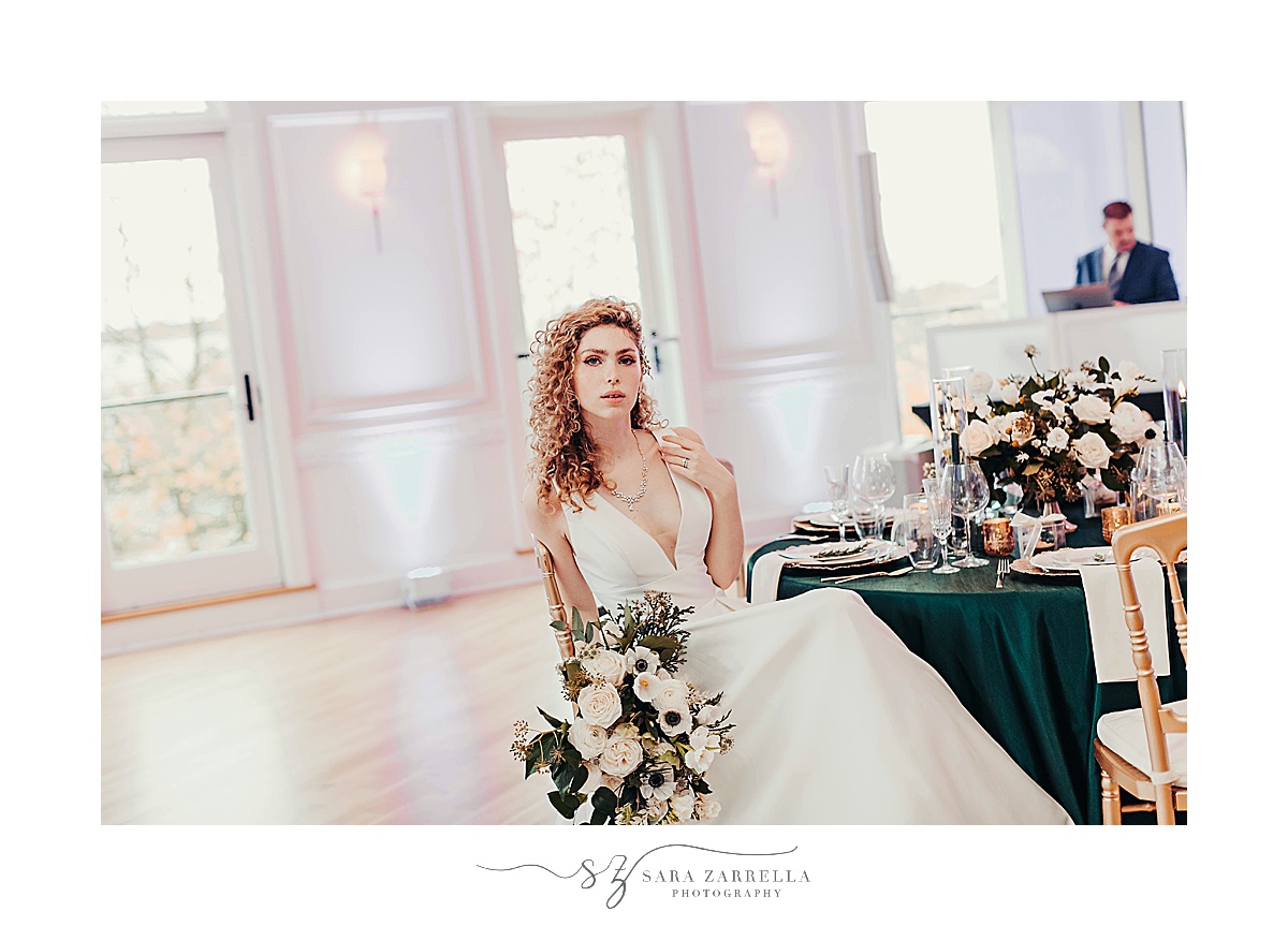 bridal portrait of bride in chair with bouquet of anemones 