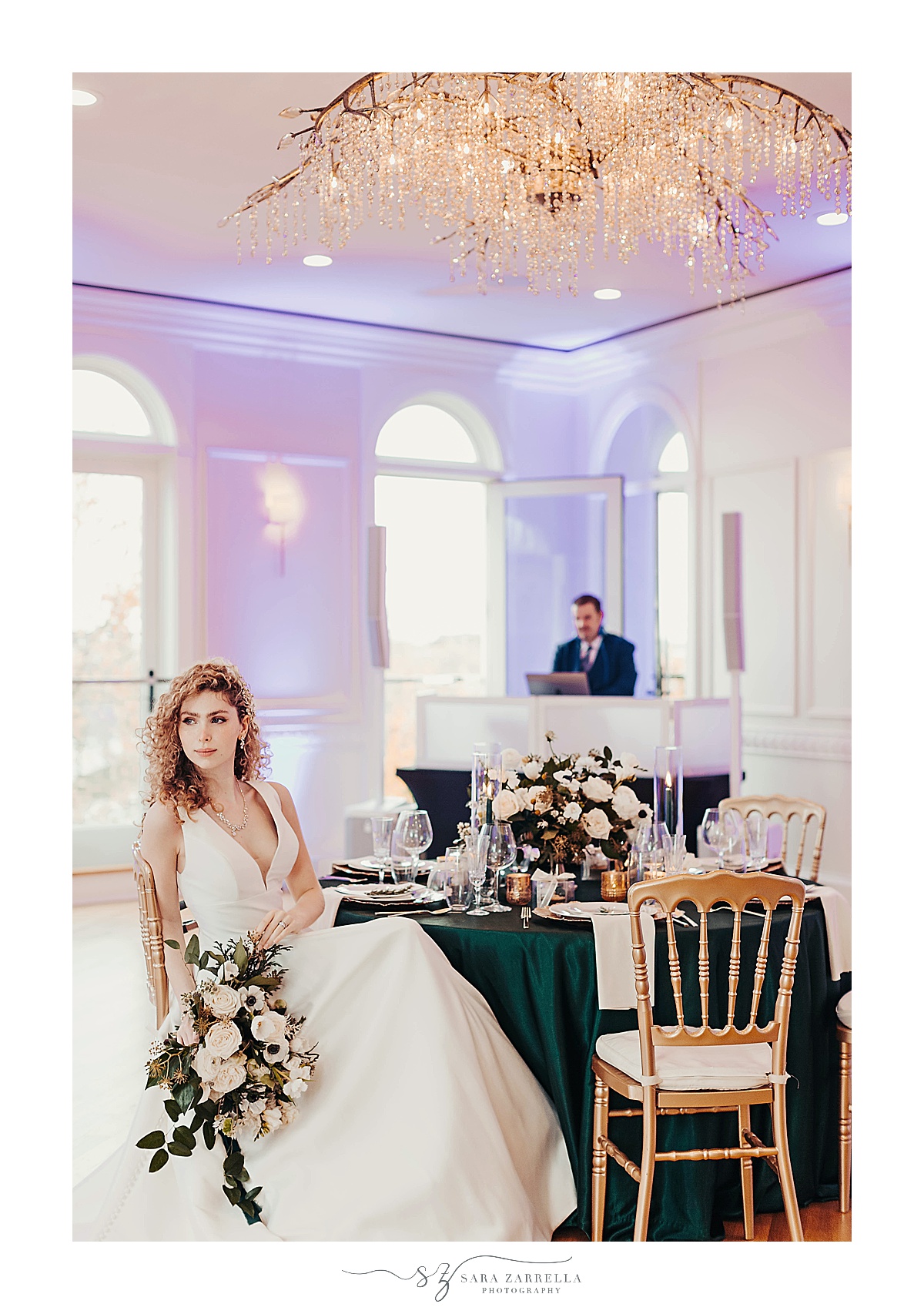 bride holds bouquet and sits at table during modern winter wedding reception 