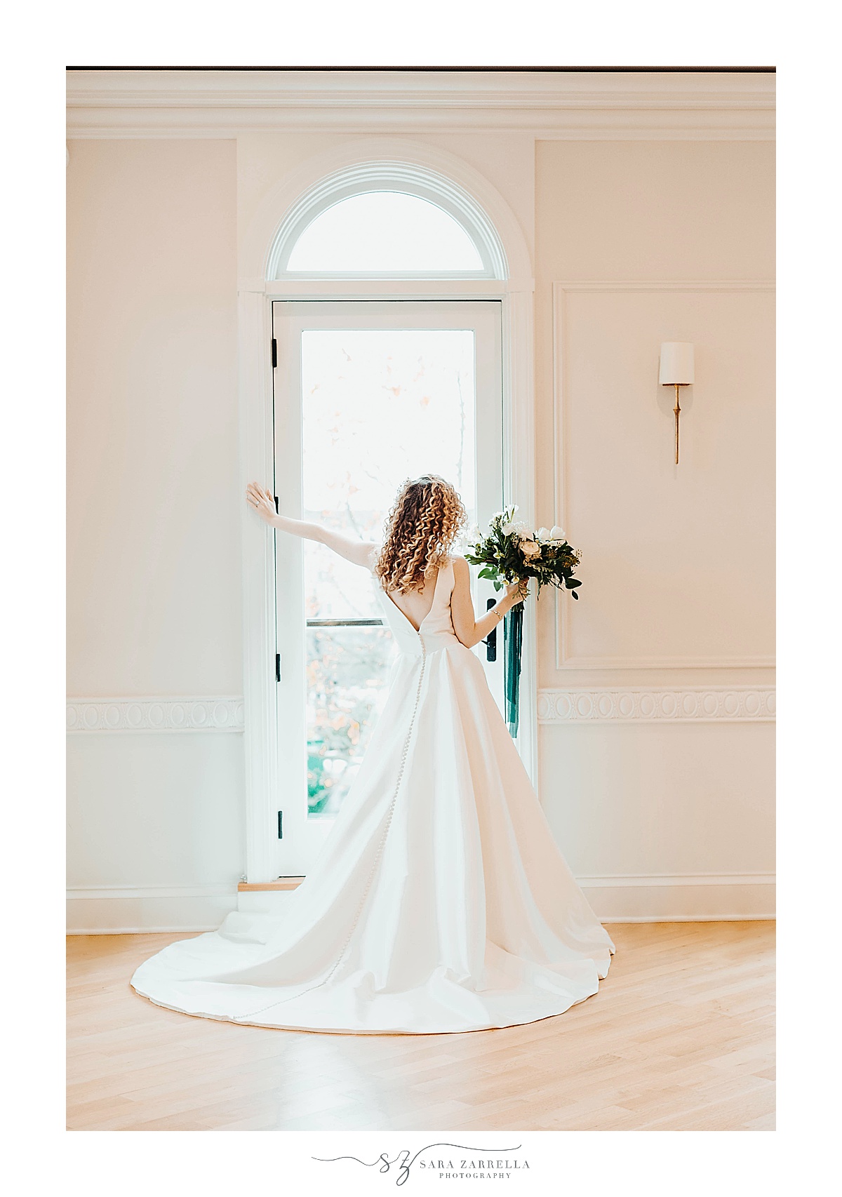 bride poses in window at Queen Anne's Loft