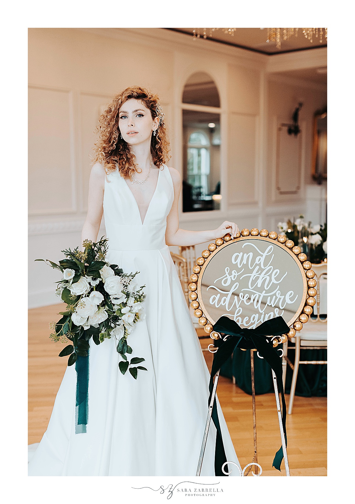 bride stands next to welcome sign with calligraphy