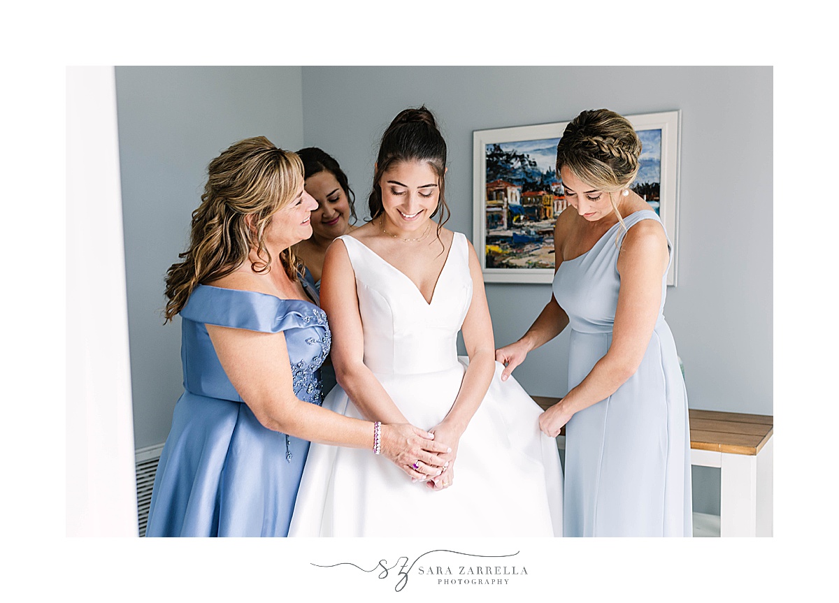 bridesmaids help bride with jewelry on wedding morning