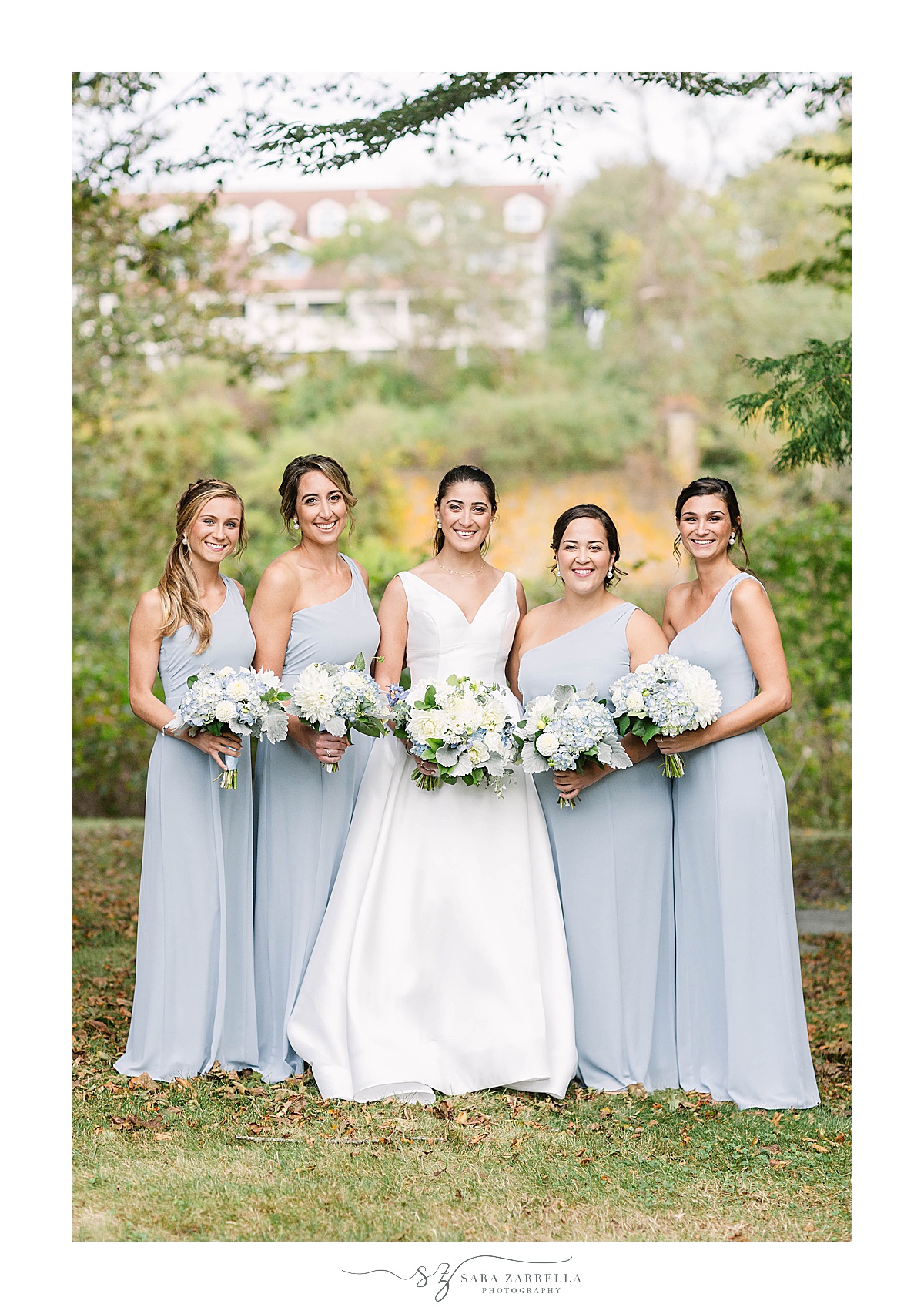 bridesmaid poses with bridesmaids in blue gowns