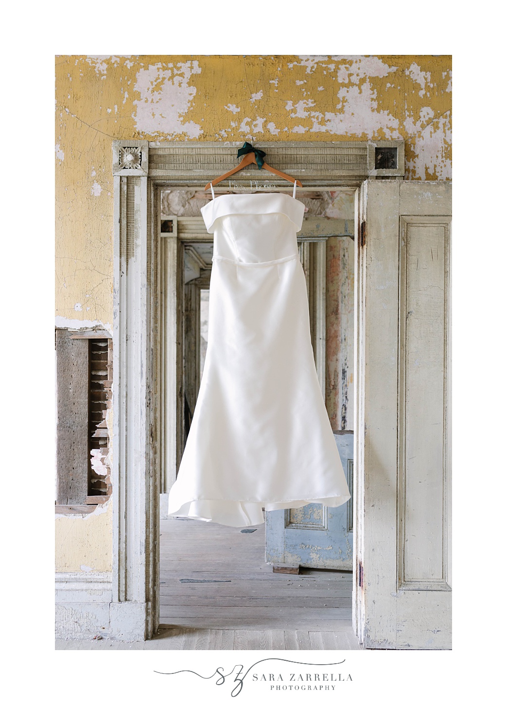 wedding dress hangs in doorway at Fort Adams