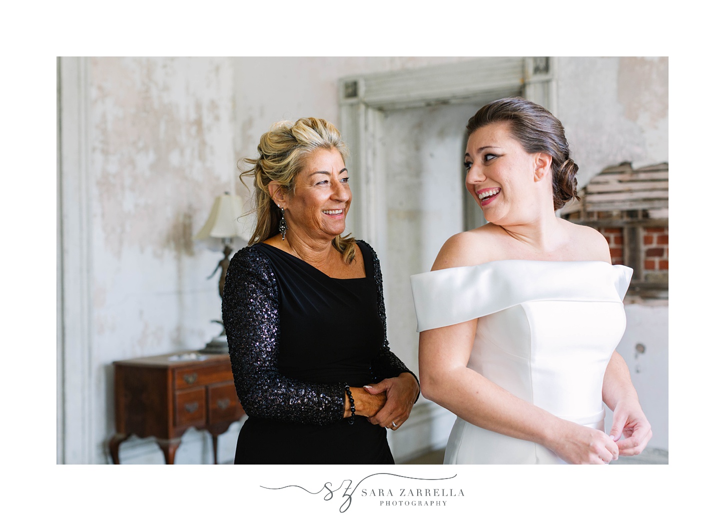 bride laughs with mom while preparing for Fort Adams wedding