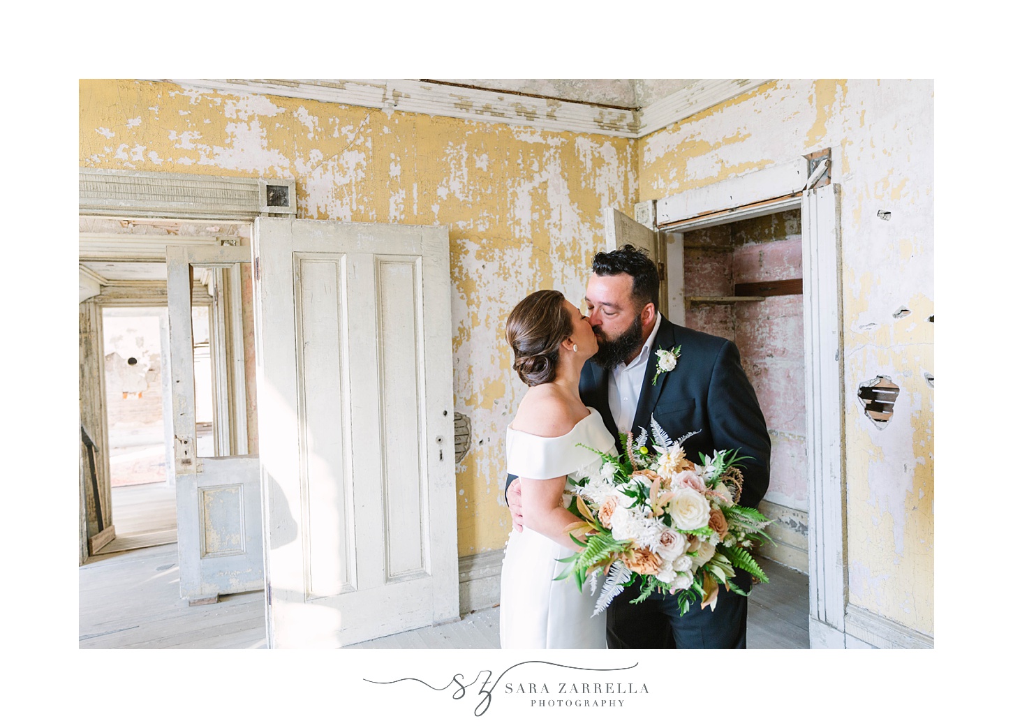 bride and groom kiss in dilapidated room of Fort Adams