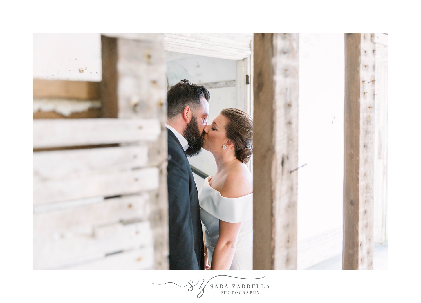 bride and groom kiss in room of Fort Adams