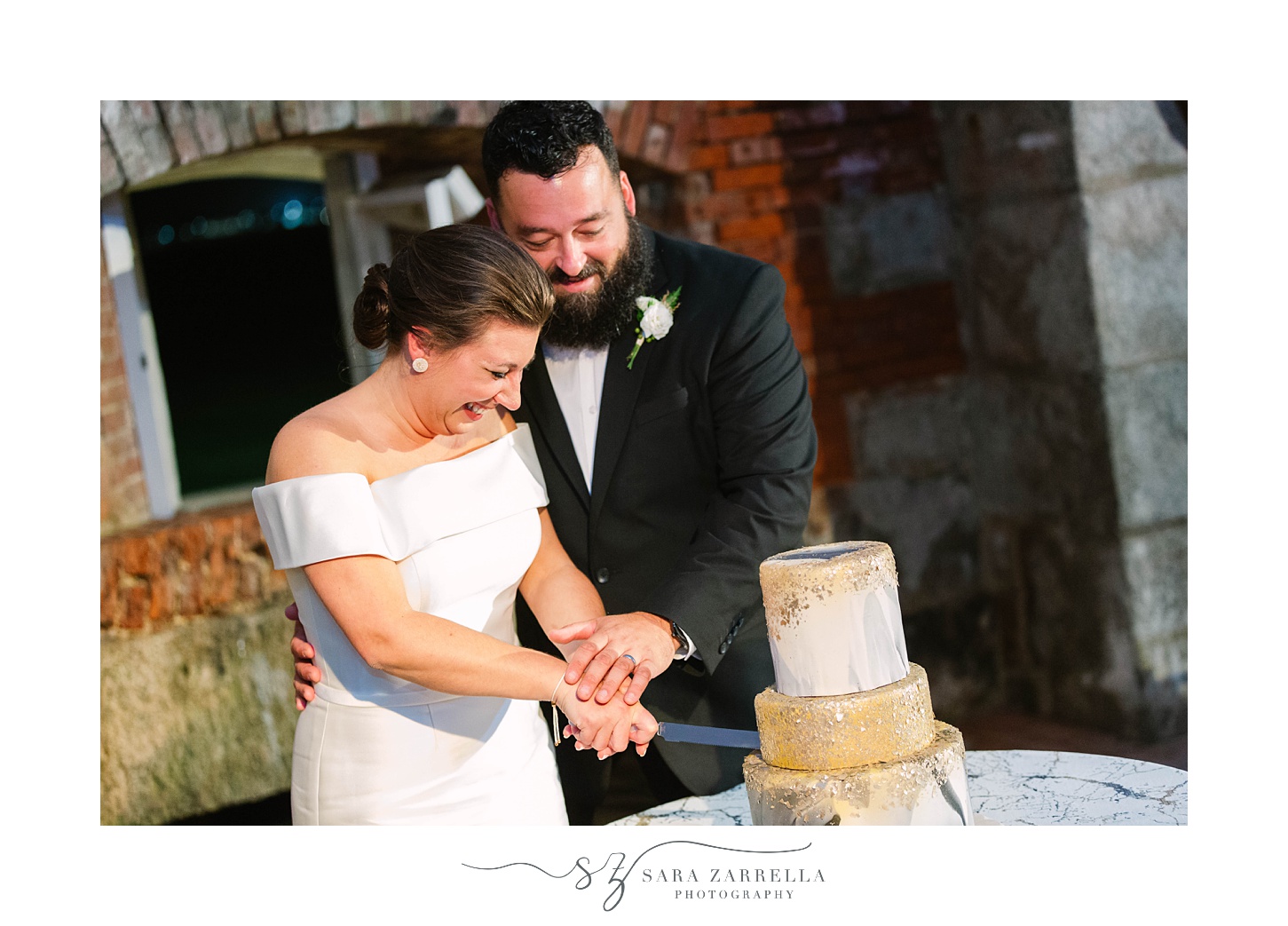 bride and groom cut wedding cake during RI wedding reception
