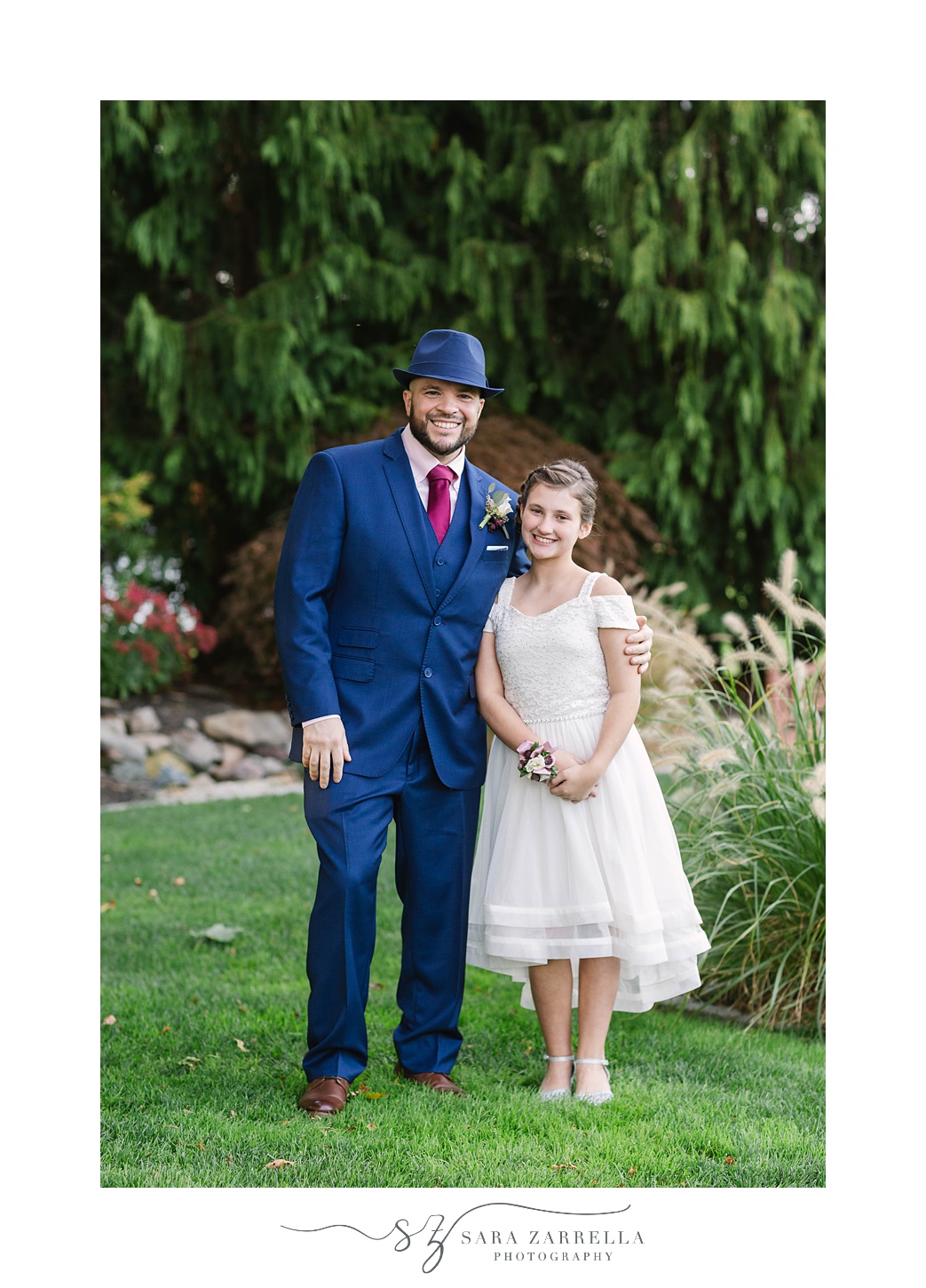 groom poses with daughter after RI wedding 