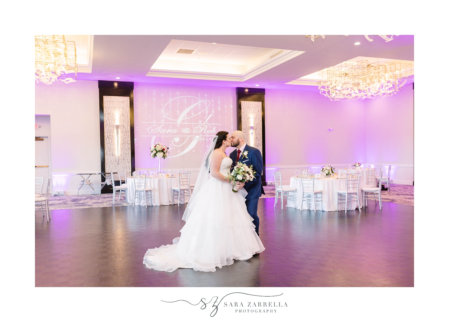 bride and groom kiss in banquet hall at Kirkbrae Country Club