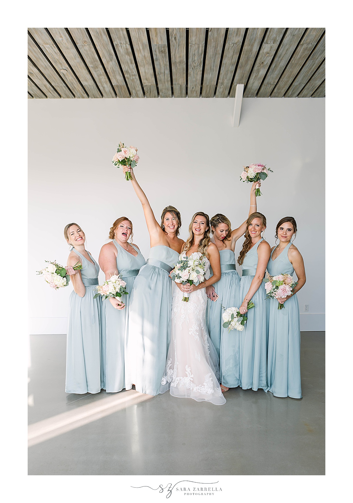 bridesmaids cheer while wearing blue gowns