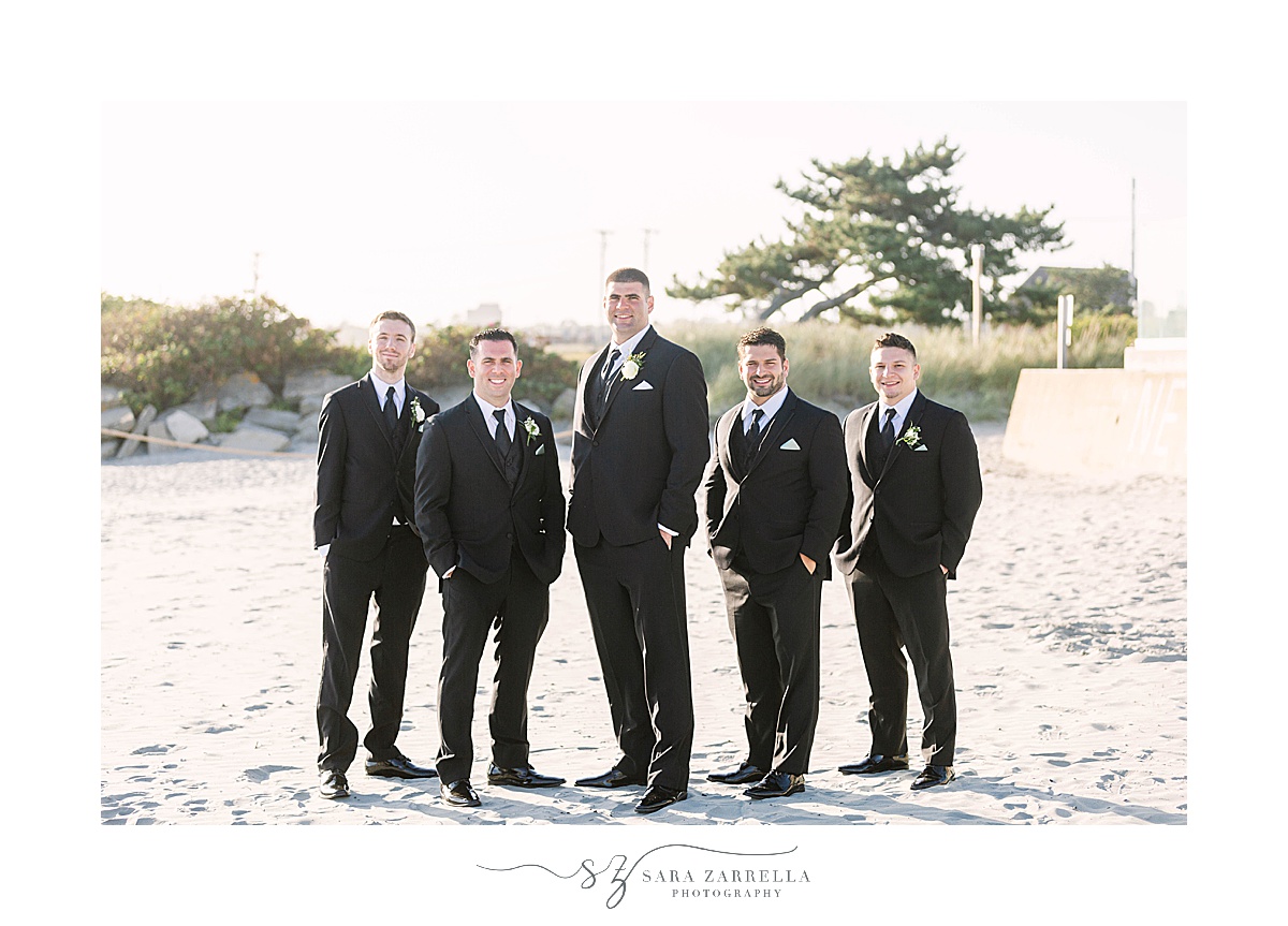groomsmen pose on Newport Beach