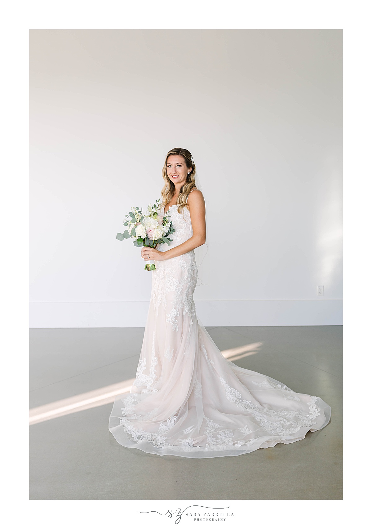 bridal portrait at Newport Beach House with bride's gown around feet
