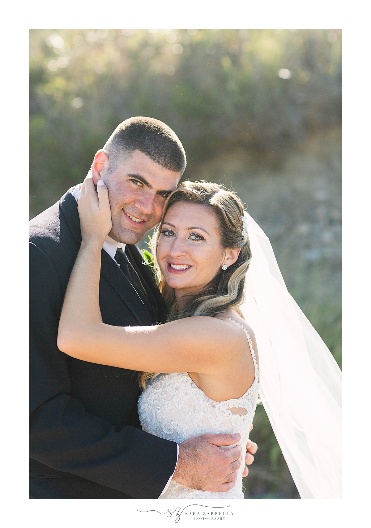 newlyweds pose with foreheads touching in front of Newport beach
