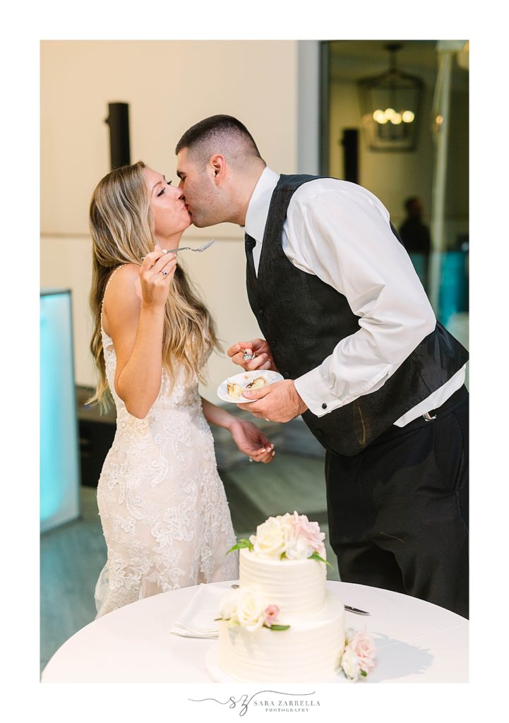 newlyweds kiss during cake cutting at Newport Beach House