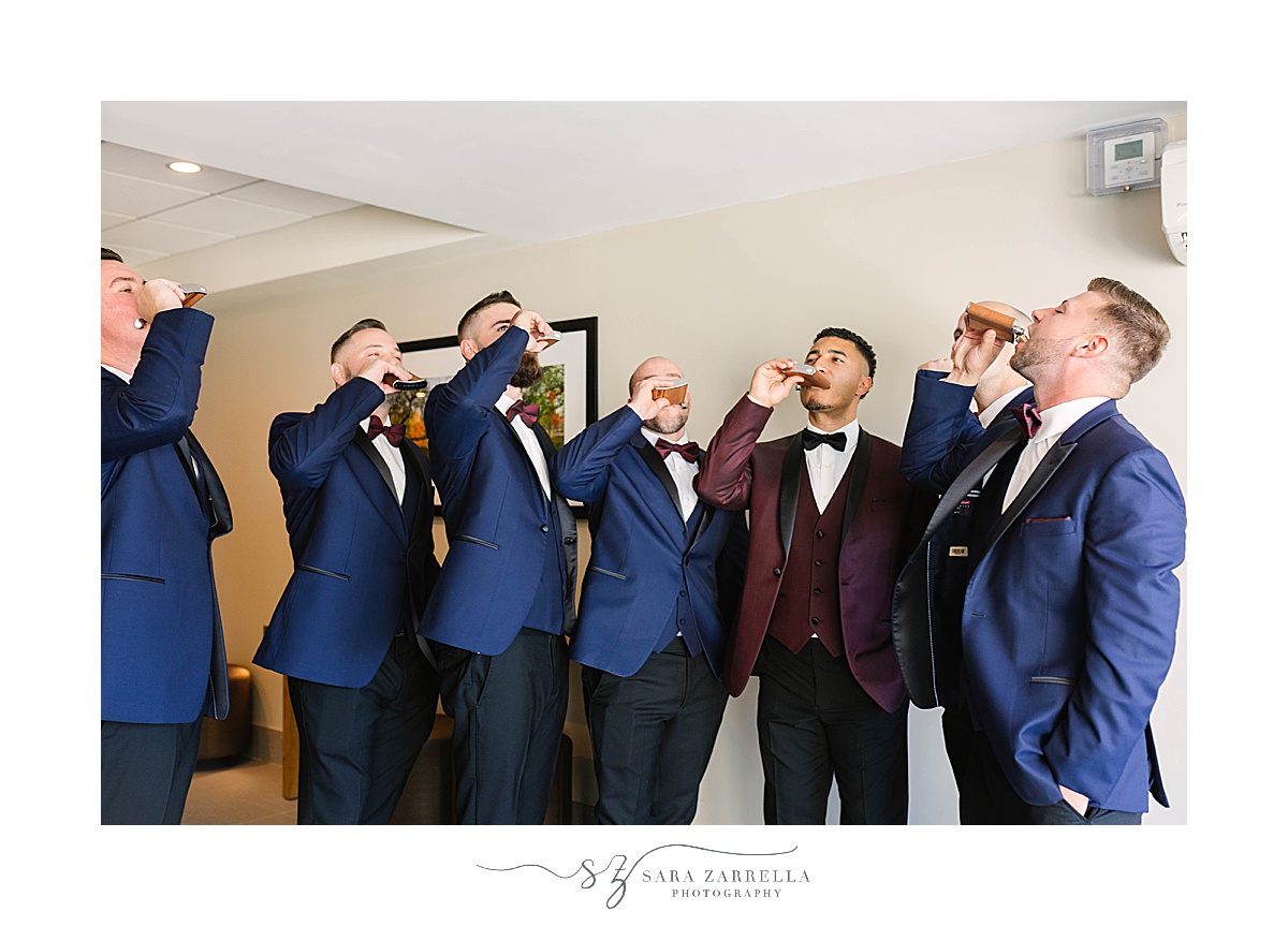groom and groomsmen drink from flasks before RI wedding