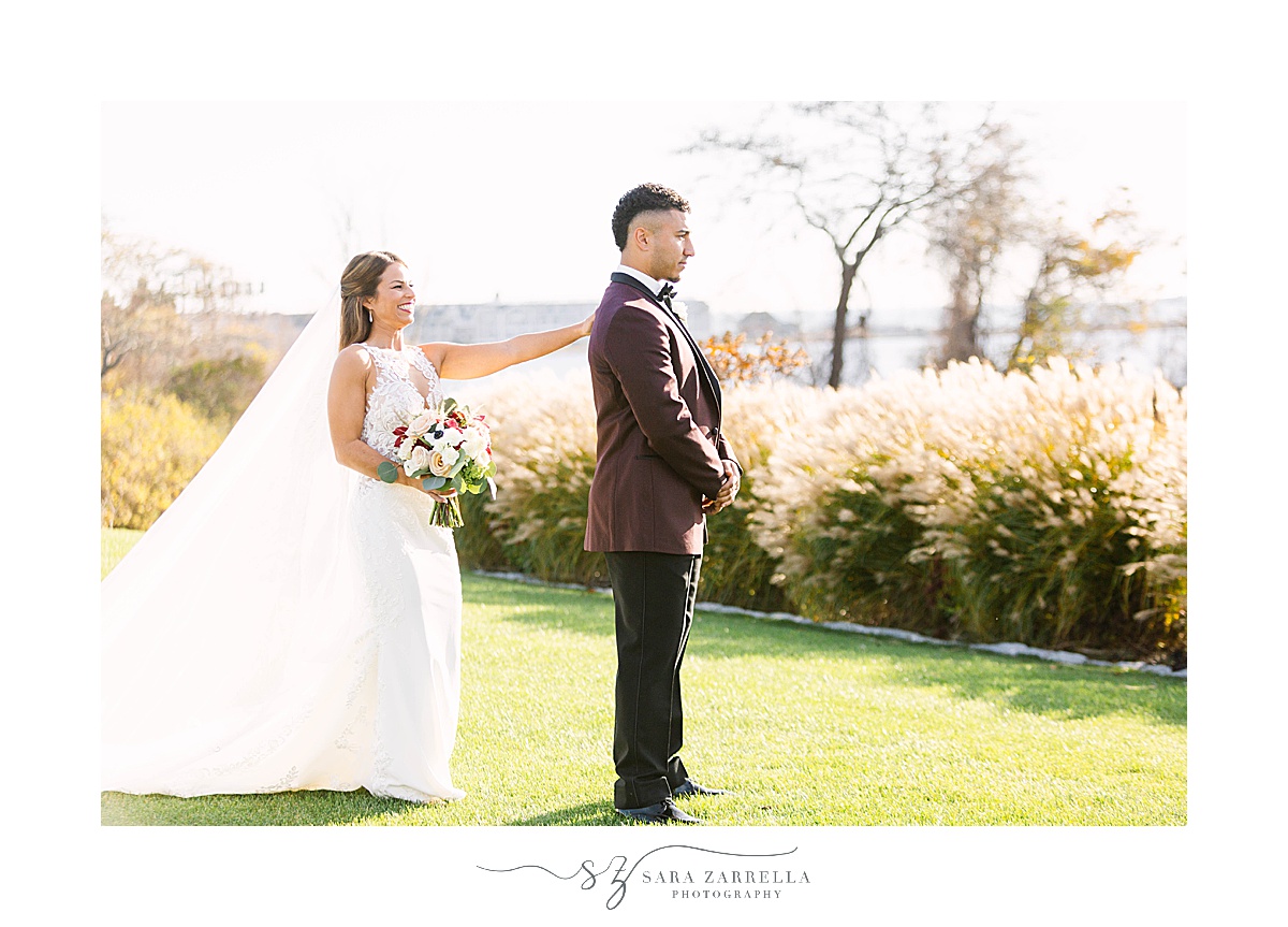 bride taps groom's shoulder during first look at Atlantic Resort Newport Wedding