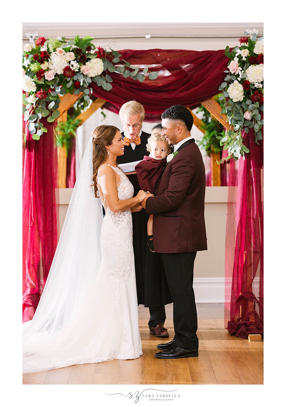 fall Atlantic Resort Newport Wedding ceremony under arbor with burgundy draping